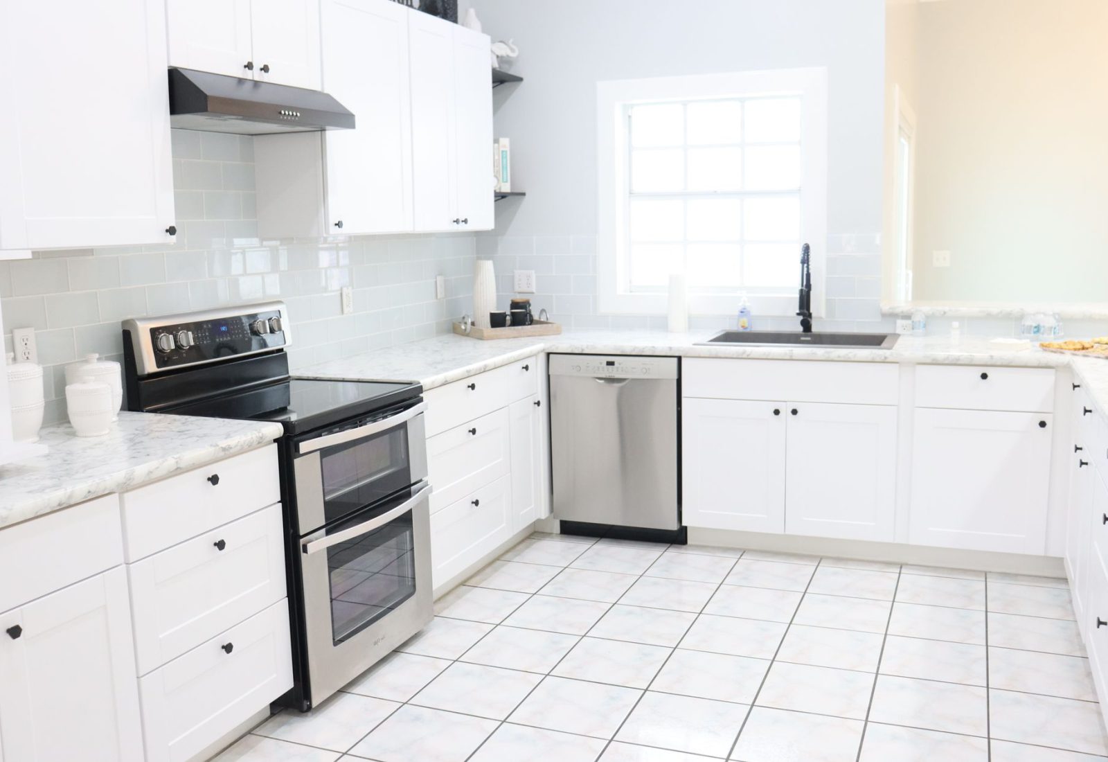 Bright, refreshed kitchen with new white cabinet doors and drawer fronts