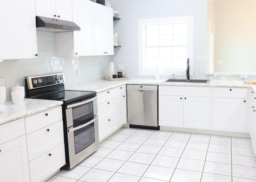 The same kitchen after new doors were fitted: Dated Oak to Bright White, Burnaby