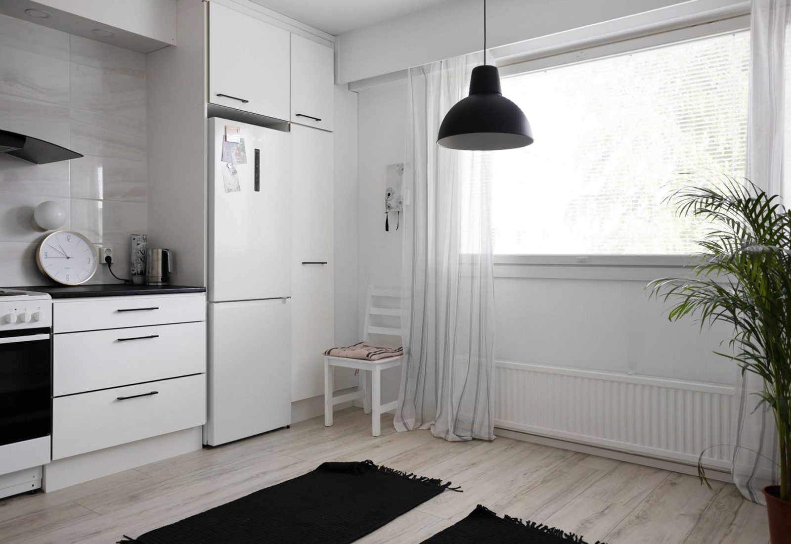 Minimal white kitchen after new handleless cabinet doors were installed