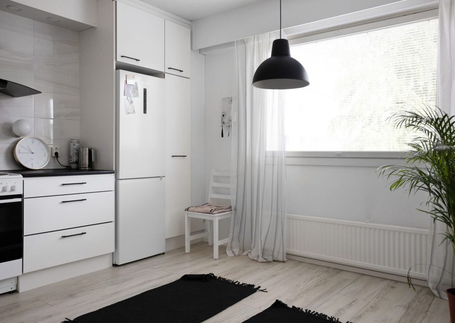 The same kitchen after new doors were fitted: Glass-Front Oak to Handleless White, Richmond